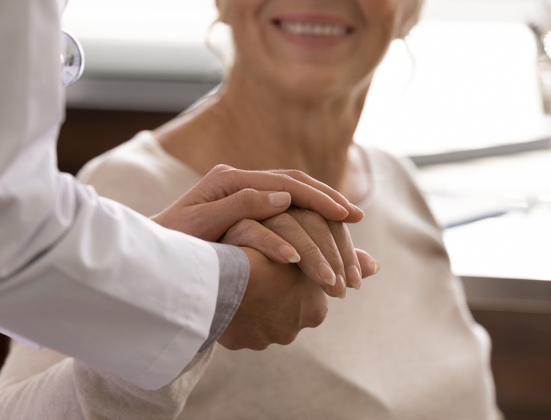 Dylan Neal PA-C holding a patients hand during a skin treatment at rocklin dermatology