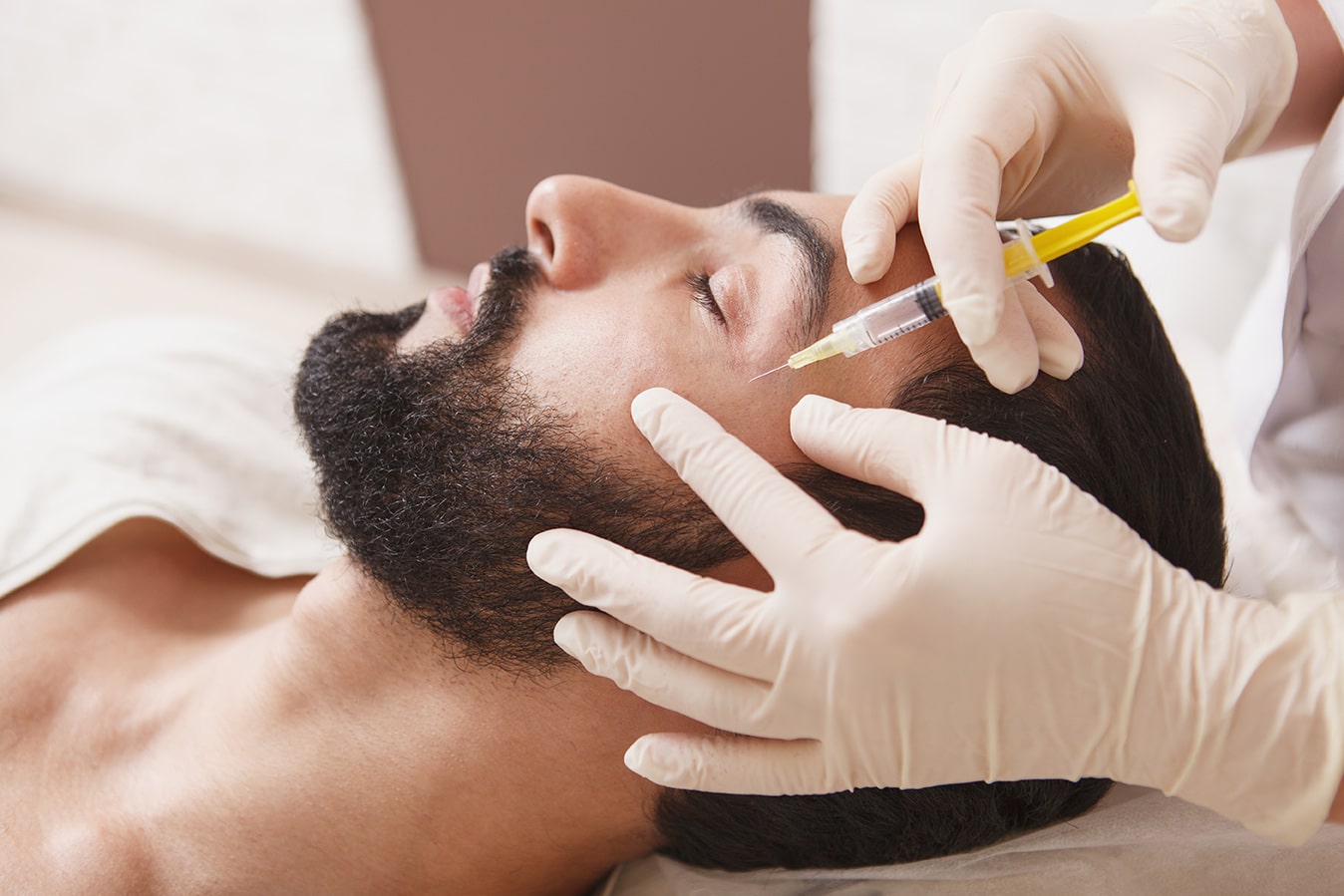 Bearded man getting anti-wrinkle face filler treatment at rocklin dermatology in rocklin california